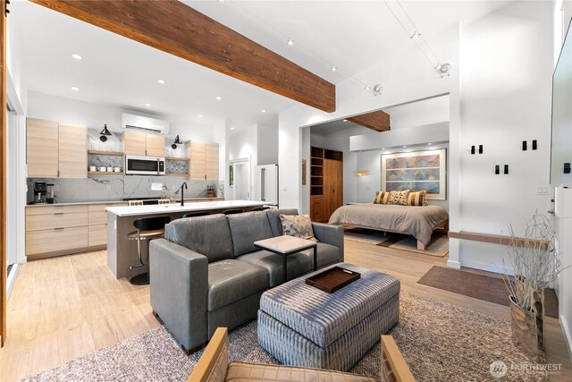 19 Davelaar Dr, Mazama, WA 98833 - living room featuring a wall mounted AC, light wood-style flooring, recessed lighting, and beamed ceiling
