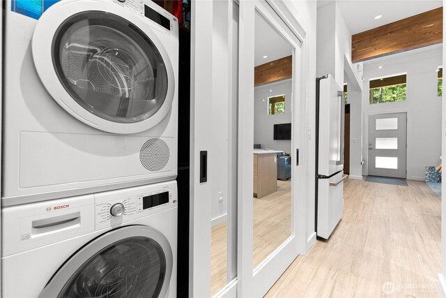 19 Davelaar Dr, Mazama, WA 98833 - washroom featuring stacked washer / dryer, light wood-type flooring, recessed lighting, and baseboards