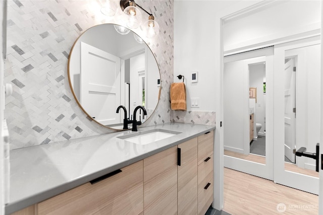 19 Davelaar Dr, Mazama, WA 98833 - bathroom with vanity, decorative backsplash, wood finished floors, and toilet