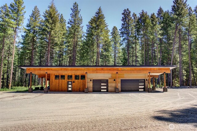 19 Davelaar Dr, Mazama, WA 98833 - garage featuring a forest view and dirt driveway