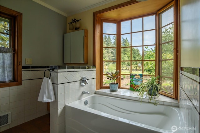 472 Redtail Ln, Lopez Island, WA 98261 - bathroom featuring a bath, tile walls, ornamental molding, and a wainscoted wall