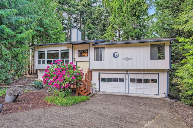 2617 35th Ave SE, Puyallup, WA 98374 - bi-level home featuring driveway, a chimney, and a garage
