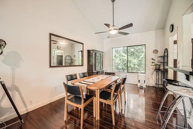 2617 35th Ave SE, Puyallup, WA 98374 - dining area with vaulted ceiling, a ceiling fan, dark wood-type flooring, a textured ceiling, and baseboards
