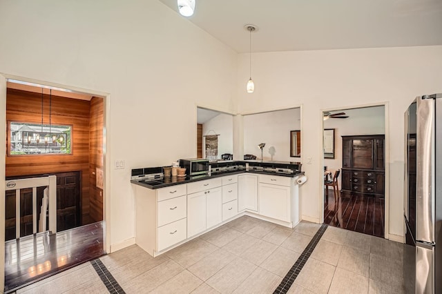 2617 35th Ave SE, Puyallup, WA 98374 - kitchen featuring appliances with stainless steel finishes, dark countertops, inlaid floor details, and high vaulted ceiling