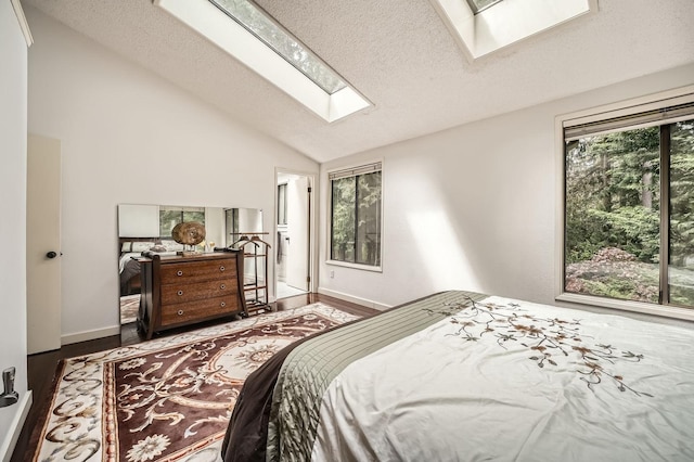 2617 35th Ave SE, Puyallup, WA 98374 - bedroom with a skylight, lofted ceiling, wood finished floors, a textured ceiling, and baseboards