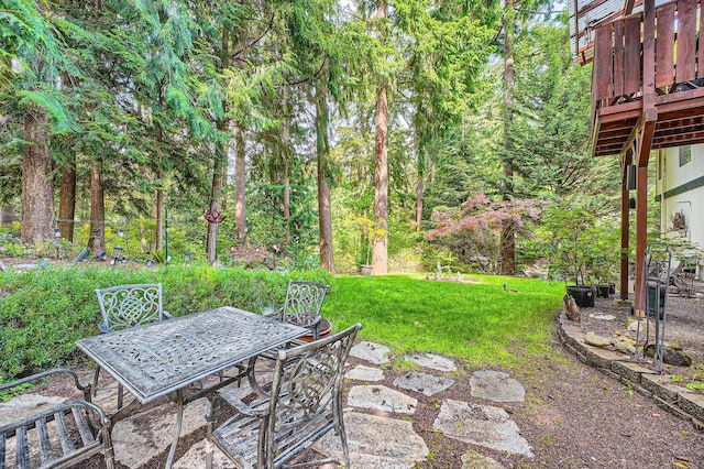 2617 35th Ave SE, Puyallup, WA 98374 - view of grassy yard featuring outdoor dining space, a patio, and a wooden deck