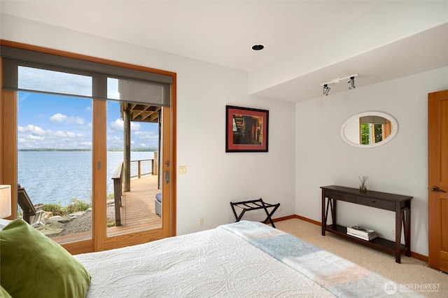2778 N Nugent Rd N, Lummi Island, WA 98262 - bedroom with access to exterior, multiple windows, a water view, and baseboards