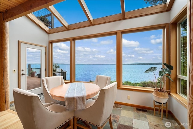 2778 N Nugent Rd N, Lummi Island, WA 98262 - sunroom featuring a skylight, a water view, baseboards, plenty of natural light, and vaulted ceiling