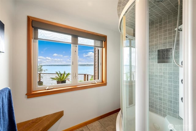 2778 N Nugent Rd N, Lummi Island, WA 98262 - full bathroom with a water view, tiled shower, tile patterned flooring, and baseboards