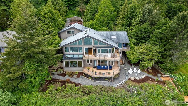 2778 N Nugent Rd N, Lummi Island, WA 98262 - rear view of house with a deck, a sunroom, a forest view, a balcony, and a patio