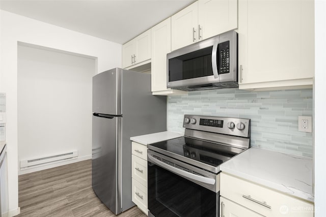19414 Aurora Ave N Unit 204, Shoreline, WA 98133 - kitchen with stainless steel appliances, baseboard heating, light countertops, backsplash, and white cabinetry