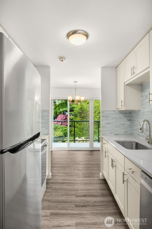 19414 Aurora Ave N Unit 204, Shoreline, WA 98133 - kitchen with appliances with stainless steel finishes, a sink, plenty of natural light, and white cabinets