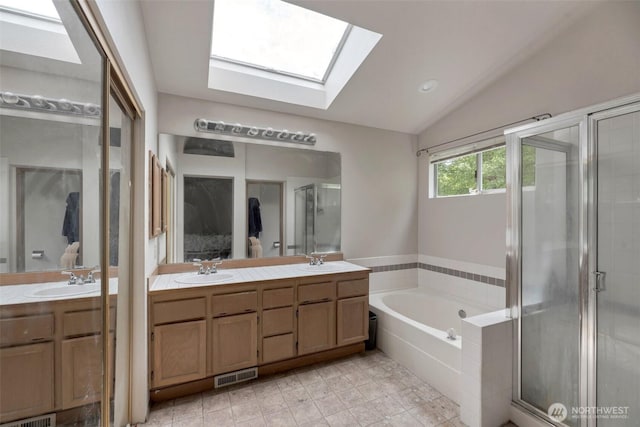 707 S 32nd, Renton, WA 98055 - bathroom featuring a skylight, double vanity, lofted ceiling, a garden tub, and a shower stall