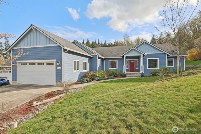 1172 Matterhorn Loop, Camano Island, WA 98282 - ranch-style home with board and batten siding, an attached garage, concrete driveway, a front yard, and a shingled roof