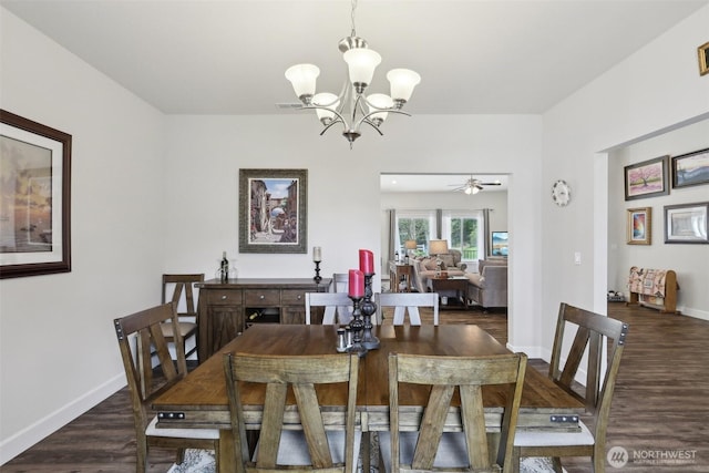 1172 Matterhorn Loop, Camano Island, WA 98282 - dining space with a chandelier, dark wood-type flooring, and baseboards