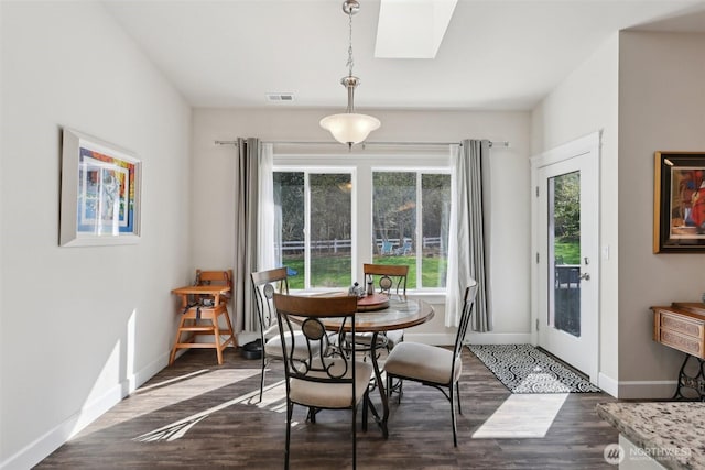 1172 Matterhorn Loop, Camano Island, WA 98282 - dining room featuring baseboards, a skylight, and dark wood-style floors