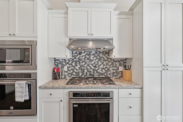 1172 Matterhorn Loop, Camano Island, WA 98282 - kitchen with stainless steel appliances, extractor fan, backsplash, and white cabinetry