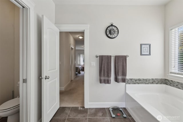 1172 Matterhorn Loop, Camano Island, WA 98282 - bathroom featuring a garden tub, toilet, baseboards, and tile patterned floors