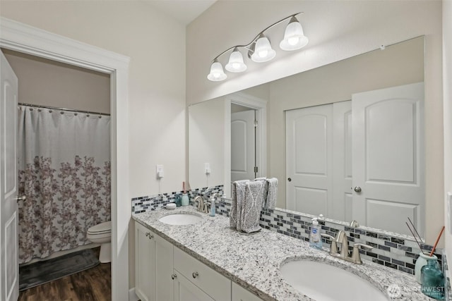 1172 Matterhorn Loop, Camano Island, WA 98282 - full bathroom with double vanity, toilet, wood finished floors, and curtained shower