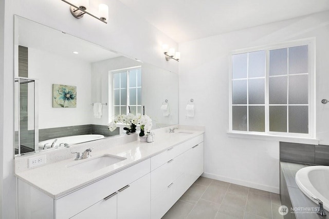 14144 270th Ln NE, Duvall, WA 98019 - bathroom featuring a bath, double vanity, baseboards, and tile patterned floors