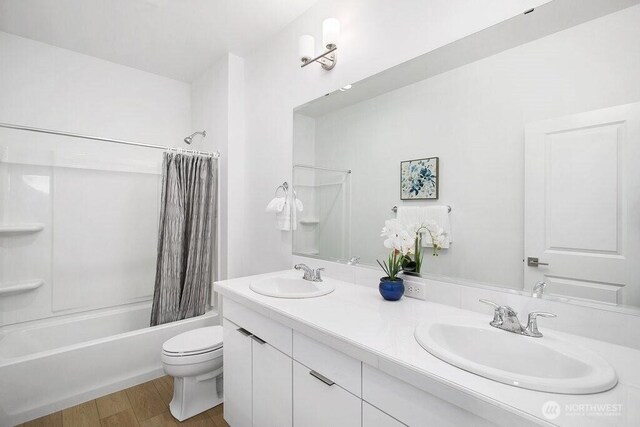14144 270th Ln NE, Duvall, WA 98019 - bathroom with toilet, double vanity, shower / tub combo, and wood finished floors