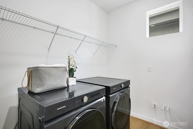 14144 270th Ln NE, Duvall, WA 98019 - laundry room featuring washing machine and dryer, wood finished floors, and baseboards