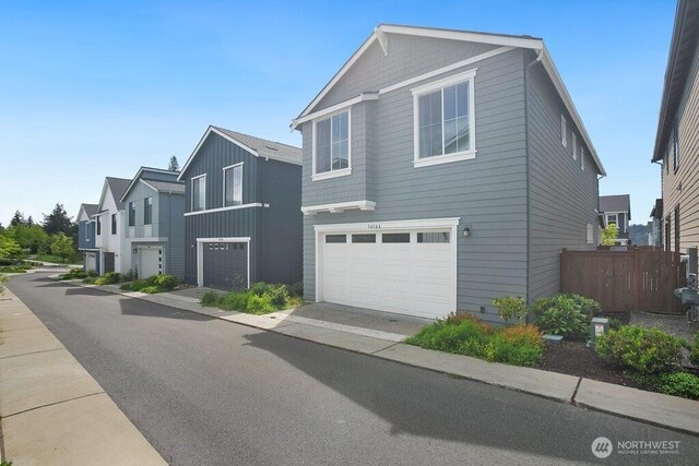 14144 270th Ln NE, Duvall, WA 98019 - view of side of home featuring an attached garage, driveway, and board and batten siding