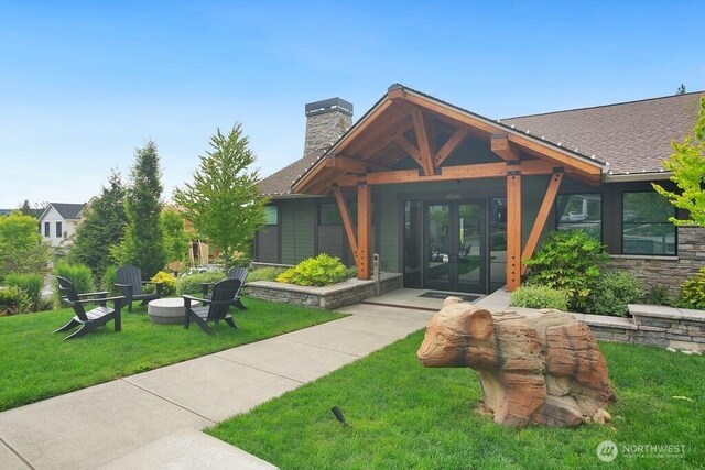 14144 270th Ln NE, Duvall, WA 98019 - entrance to property with french doors, a chimney, a lawn, and roof with shingles