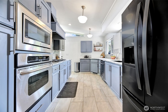 1302 Park Ave, Snohomish, WA 98290 - kitchen with stainless steel appliances, open shelves, light countertops, decorative backsplash, and premium range hood