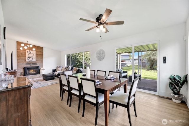 1302 Park Ave, Snohomish, WA 98290 - dining space with lofted ceiling, light wood finished floors, plenty of natural light, a large fireplace, and ceiling fan