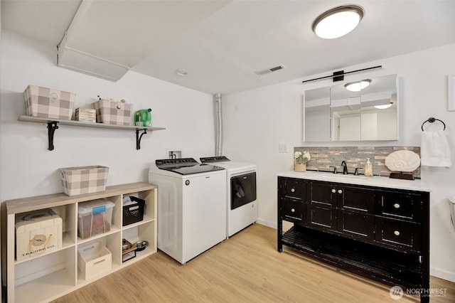 1302 Park Ave, Snohomish, WA 98290 - washroom featuring washing machine and dryer and light wood-style flooring