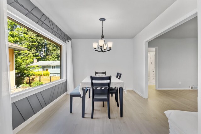 7715 236th St SW, Edmonds, WA 98026 - dining room with a chandelier, healthy amount of natural light, light wood-type flooring, and baseboards