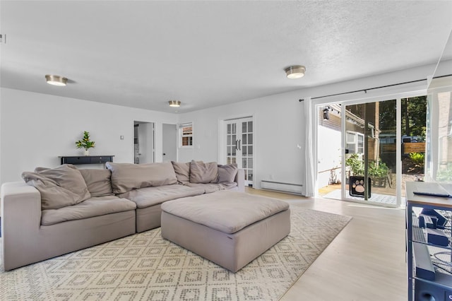 7715 236th St SW, Edmonds, WA 98026 - living area with baseboard heating, wood finished floors, and a textured ceiling