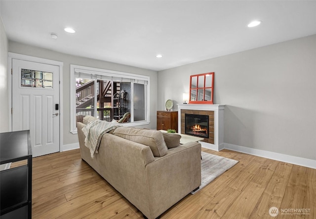 21301 48th Ave W Unit A104, Mountlake Terrace, WA 98043 - living area featuring baseboards, light wood-type flooring, recessed lighting, and a tiled fireplace