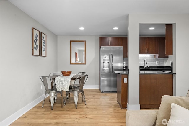 21301 48th Ave W Unit A104, Mountlake Terrace, WA 98043 - kitchen featuring stainless steel fridge, dark countertops, recessed lighting, baseboards, and light wood-type flooring