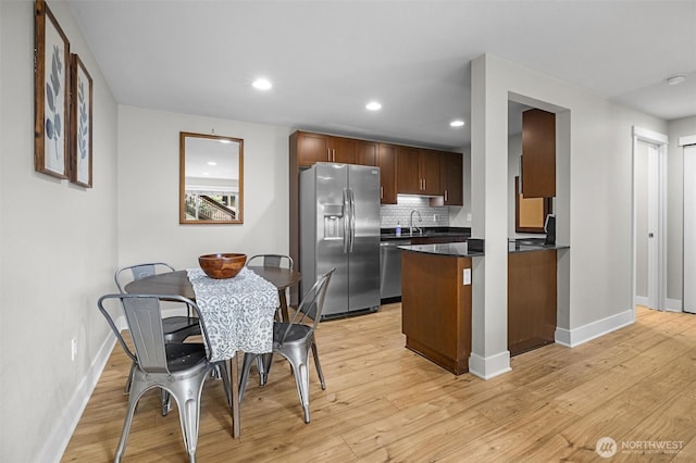 21301 48th Ave W Unit A104, Mountlake Terrace, WA 98043 - kitchen with stainless steel appliances, dark countertops, baseboards, light wood-style flooring, and recessed lighting