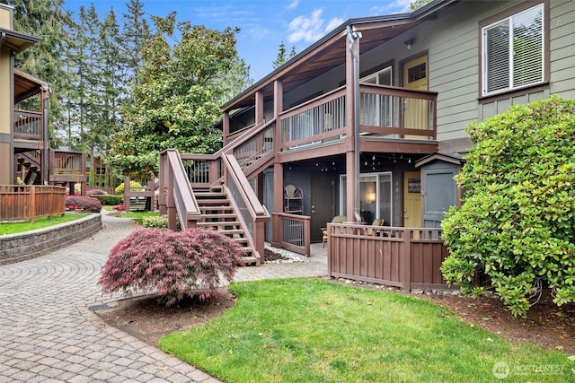 21301 48th Ave W Unit A104, Mountlake Terrace, WA 98043 - back of house with stairway, a deck, and a yard