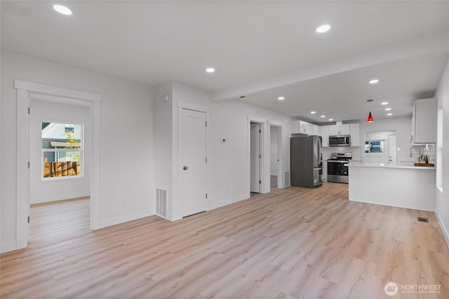 3514 S Tyler St, Tacoma, WA 98409 - unfurnished living room with light wood-style flooring, recessed lighting, and baseboards