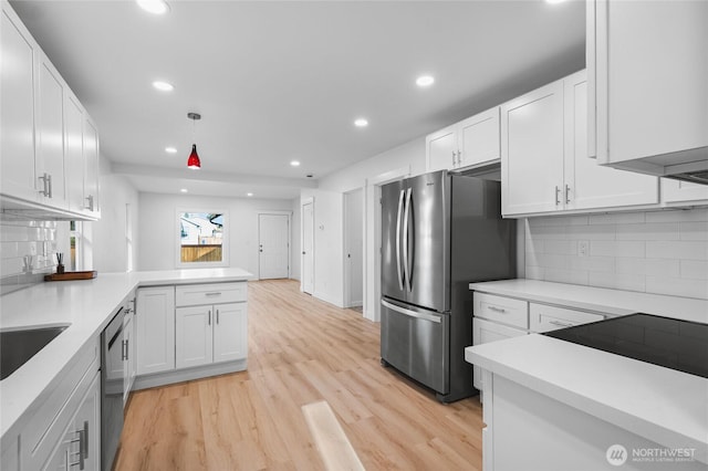 3514 S Tyler St, Tacoma, WA 98409 - kitchen featuring freestanding refrigerator, white cabinetry, light countertops, recessed lighting, and light wood-type flooring