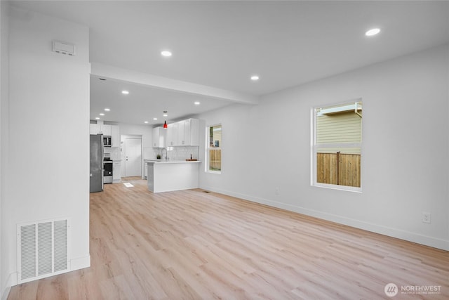3514 S Tyler St, Tacoma, WA 98409 - unfurnished living room featuring recessed lighting, light wood-style flooring, baseboards, and a sink