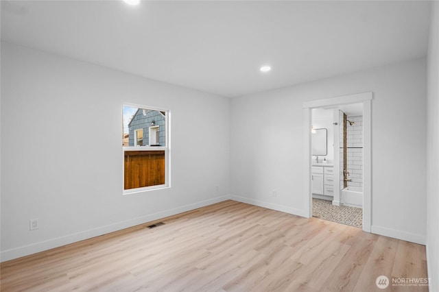 3514 S Tyler St, Tacoma, WA 98409 - unfurnished bedroom with wood finished floors, recessed lighting, baseboards, ensuite bathroom, and a sink