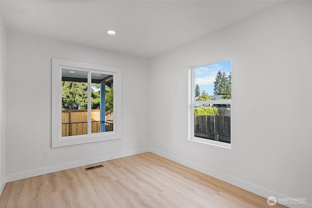 3514 S Tyler St, Tacoma, WA 98409 - empty room featuring healthy amount of natural light, baseboards, wood finished floors, and recessed lighting