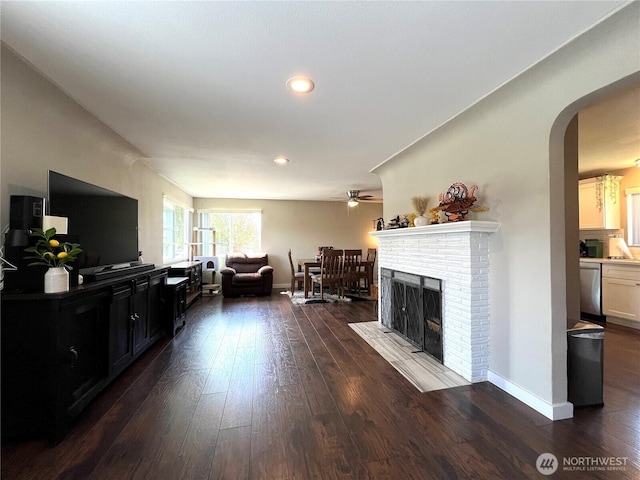 6612 E B St, Tacoma, WA 98404 - living room with dark wood-type flooring, ceiling fan, arched walkways, a fireplace, and recessed lighting