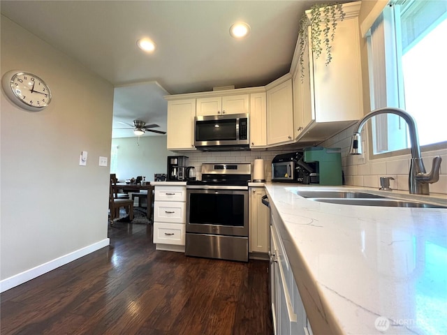 6612 E B St, Tacoma, WA 98404 - kitchen featuring appliances with stainless steel finishes, a sink, tasteful backsplash, baseboards, and recessed lighting