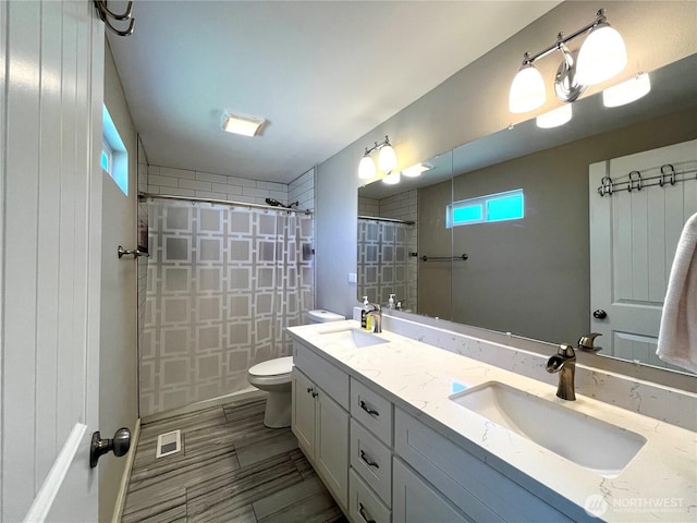6612 E B St, Tacoma, WA 98404 - bathroom with double vanity, tiled shower, and toilet