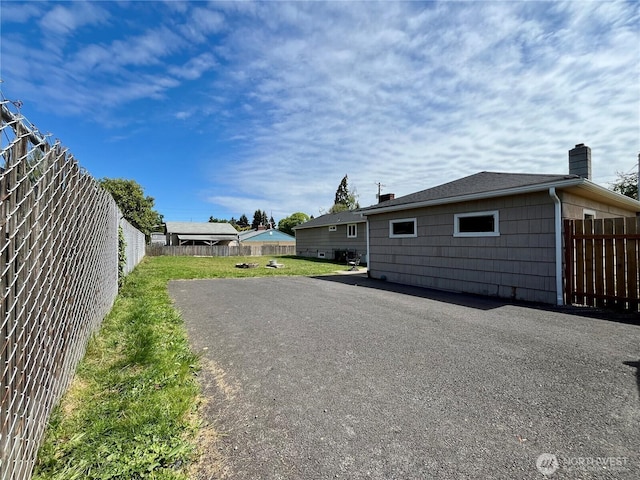 6612 E B St, Tacoma, WA 98404 - rear view of house featuring a chimney