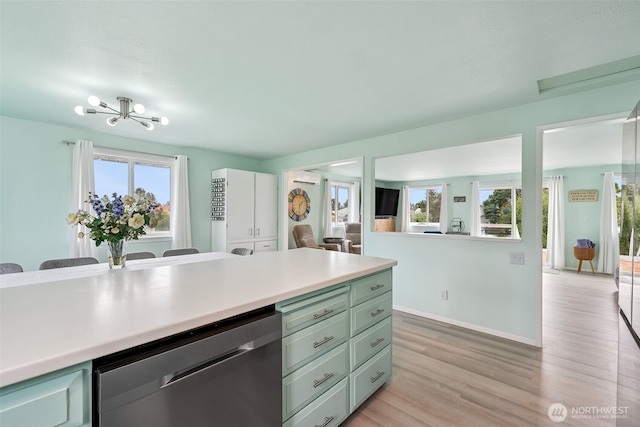 177 N Razor Clam Dr SW, Ocean Shores, WA 98569 - kitchen featuring dishwasher, green cabinetry, light wood-style flooring, light countertops, and baseboards