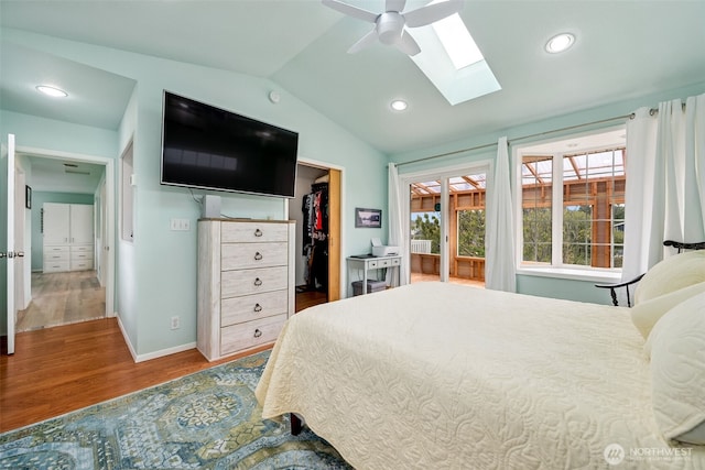 177 N Razor Clam Dr SW, Ocean Shores, WA 98569 - bedroom with a skylight, vaulted ceiling, wood finished floors, a spacious closet, and baseboards