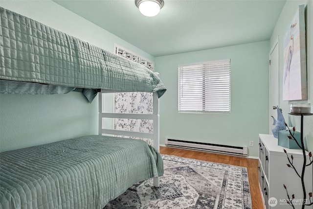 177 N Razor Clam Dr SW, Ocean Shores, WA 98569 - bedroom with a baseboard radiator and wood finished floors