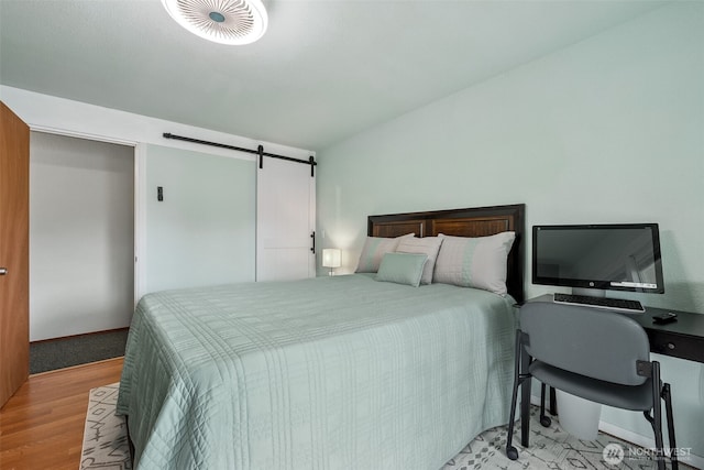177 N Razor Clam Dr SW, Ocean Shores, WA 98569 - bedroom featuring light wood-style floors and a barn door